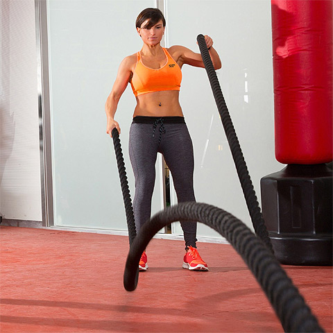 Girl using battle ropes