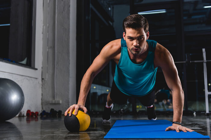 man doing exercise with medicine ball