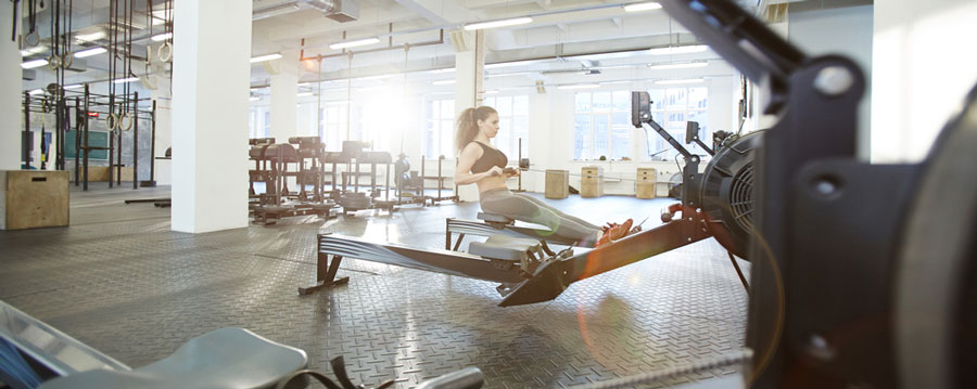 woman exercising on rowing machine