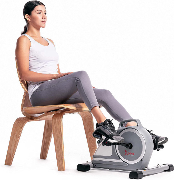 Woman using desk cycle