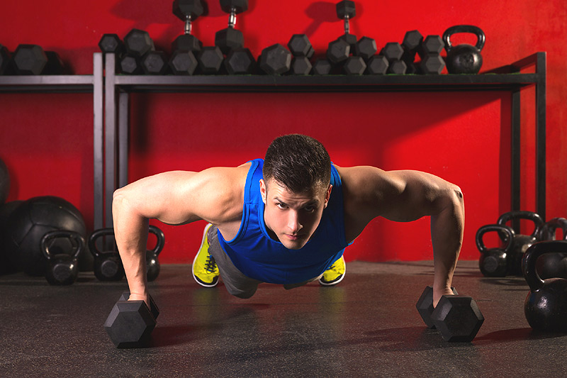 Guy doing dumbbell push-ups