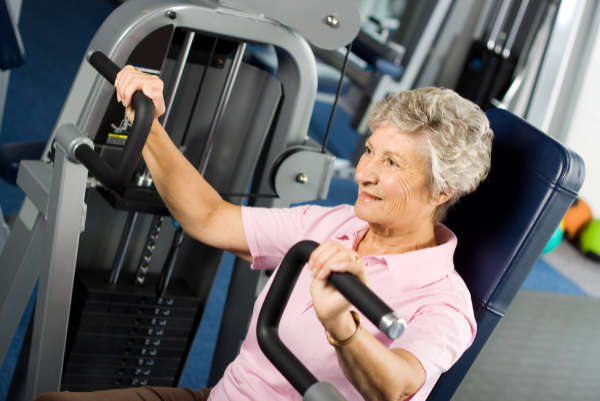 Senior lady on exercise machine